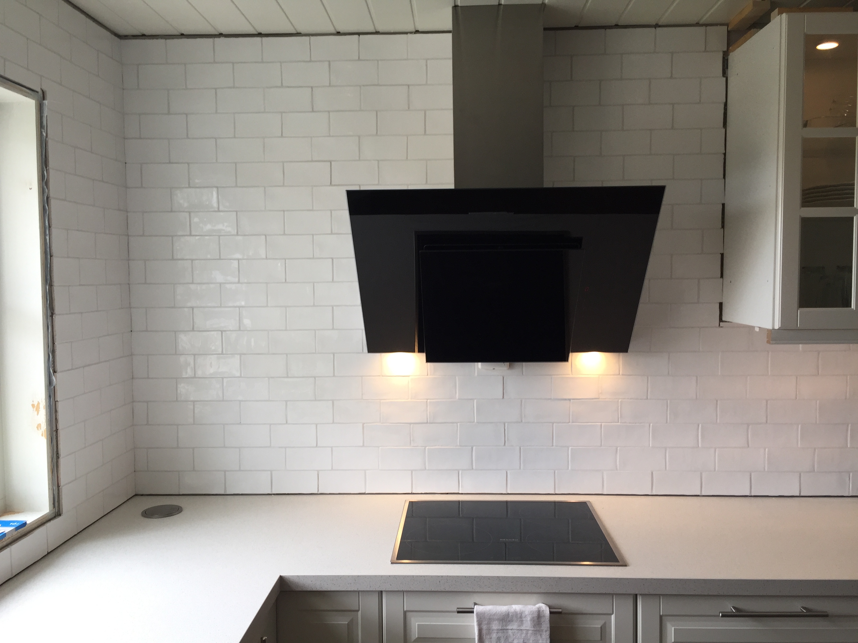 Totalrenovering av kjøkken. Lagt fliser på vegg og montert avtrekk